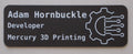 Name tag with 'Adam Hornbuckle' and 'Developer' text, featuring a gear icon, on a black background.