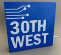 Blue sign with '30th West' text on a gray background